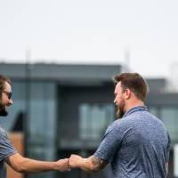 Jake Mallekoote and Matt DeRuiter smiling and fist-bumping each other